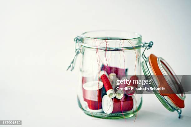 canning jar filled with several red yarn rolls - yarn art stock pictures, royalty-free photos & images