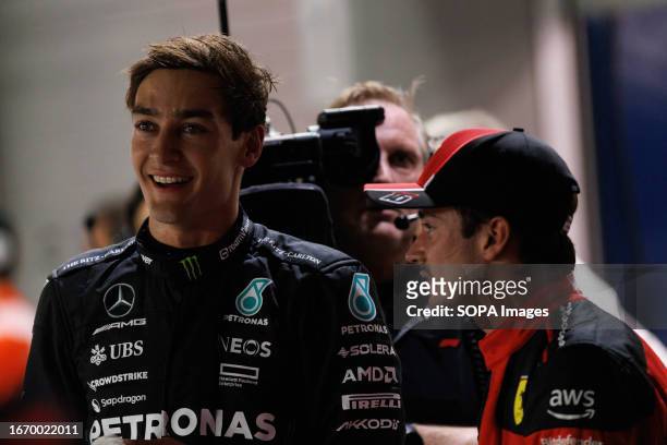 George Russell of Great Britain and Mercedes-AMG PETRONAS Formula One Team and Charles Leclerc of Monaco and Scuderia Ferrari talking after...