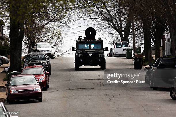 Police tactical unit drives through the streets as they search for 19-year-old bombing suspect Dzhokhar A. Tsarnaev on April 19, 2013 in Watertown,...