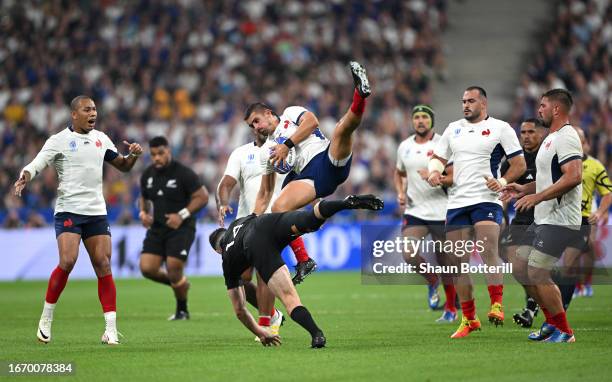 Thomas Ramos of France is tackled in the air by Will Jordan of New Zealand during the Rugby World Cup France 2023 match between France and New...