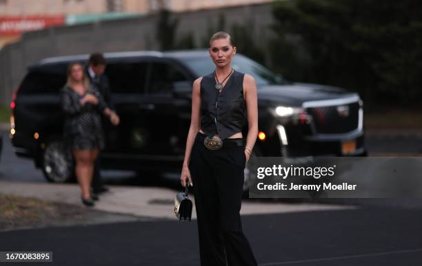Elsa Hosk is seen outside Ralph Lauren show wearing black amulet necklace, black leather Ralph Lauren vest, big medal Ralph Laurent belt, black Ralph...