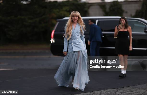 Kathryn Newton is seen outside Ralph Lauren show wearing baby blue Ralph Lauren blazer with silver buttons and a matching layered Ralph Lauren long...