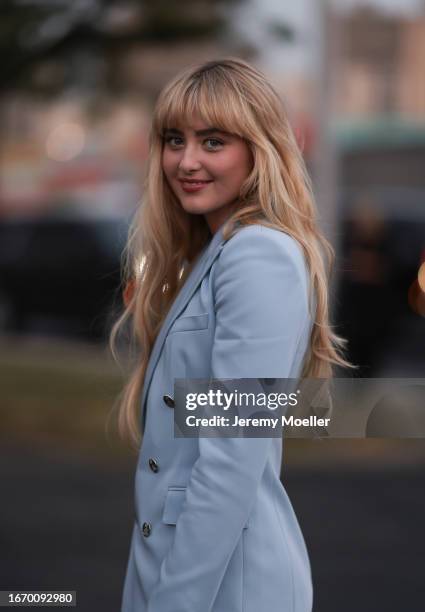 Kathryn Newton is seen outside Ralph Lauren show wearing baby blue Ralph Lauren blazer with silver buttons and a matching layered Ralph Lauren long...