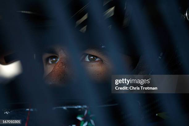 Darrell Wallace Jr., driver of the LibertyTireRecycling/Ground SmartRubber Toyota, sits in his car in the garage area during practice for the NASCAR...