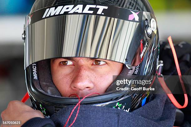 Darrell Wallace Jr., driver of the LibertyTireRecycling/Ground SmartRubber Toyota, puts on his helmet in the garage prior to practice for the NASCAR...