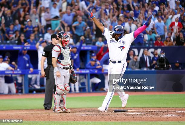 Vladimir Guerrero Jr. #27 of the Toronto Blue Jays celebrates scoring the winning run on a single by Whit Merrifield in the thirteenth inning against...