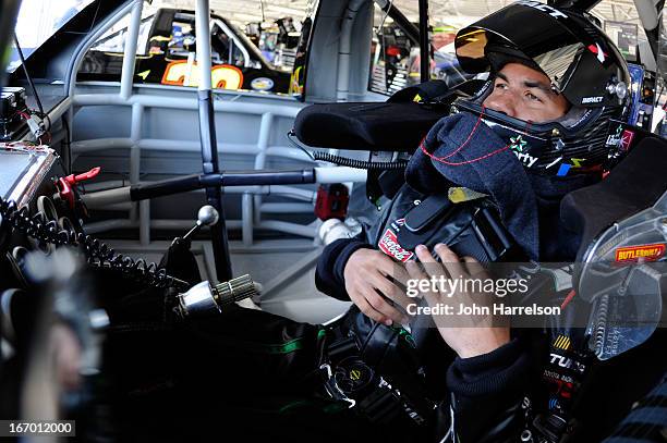 Darrell Wallace Jr., driver of the LibertyTireRecycling/Ground SmartRubber Toyota, sits in his car in the garage area during practice for the NASCAR...