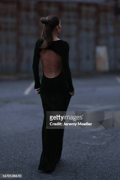 Camila Coelho is seen outside Ralph Lauren show wearing gold earrings and a dark green velvet Ralph Lauren body fitted dress on September 08, 2023 in...