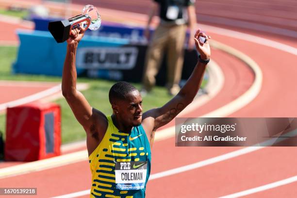 Christian Coleman of the United States holds up the Diamond League Final trophy after winning the the Men's 100m at Hayward Field on September 16,...