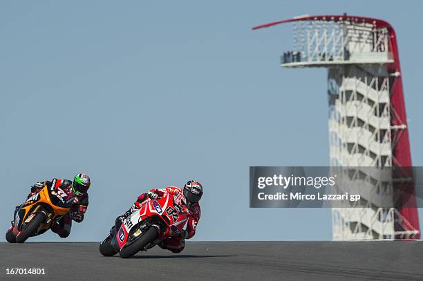 Andrea Dovizioso of Italy and Ducati Marlboro Team leads Claudio Corti of Italy and NGM Mobile Forward Racing during the MotoGp Red Bull U.S. Grand...