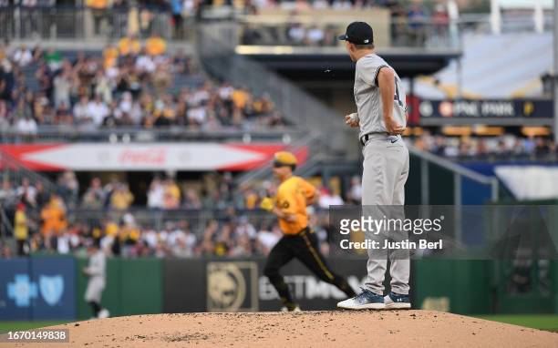 Luke Weaver of the New York Yankees steps off the mound as Bryan Reynolds of the Pittsburgh Pirates rounds the bases after hitting a two run home run...