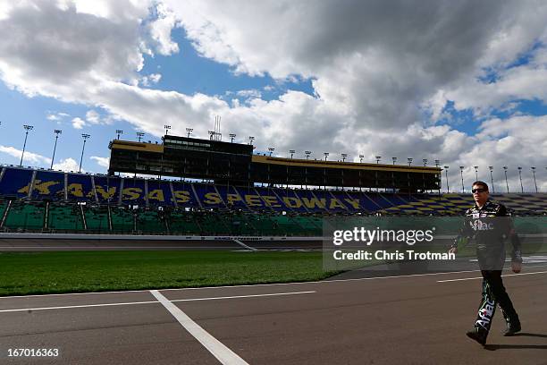 Carl Edwards, driver of the Aflac Ford, walks on pit road during qualifying for the NASCAR Sprint Cup Series STP 400 at Kansas Speedway on April 19,...