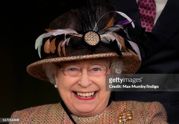 Queen Elizabeth II watches her horse 'Sign Manual' win the Dreweatts Handicap Stakes as she attends the Dubai Duty Free Raceday at Newbury Racecourse...