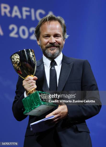 Peter Sarsgaard poses with the Best Actor Award for 'Memory' on stage during the Awards ceremony at the 80th Venice International Film Festival on...