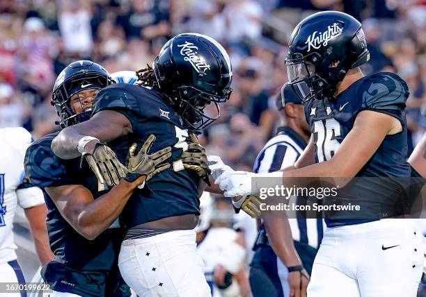 Knights running back Jordan McDonald scores a touchdown and celebrates during the NCAA football game between the UCF Knights and the Villanova...