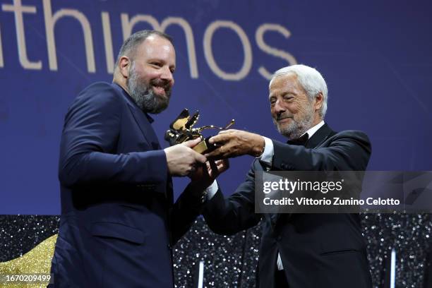 Yorgos Lanthimos receives the Golden Lion for Best Film for 'Poor Things' from President of the Venice Biennale Roberto Cicutto on stage during the...