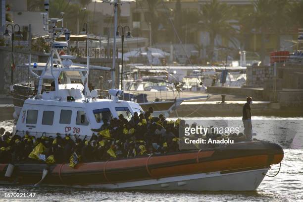 Patrol boat of the Italian Coastguard arrives at molo Favaloro with migrants, on September 16, 2023 in Lampedusa, Italy. The small Sicilian island of...