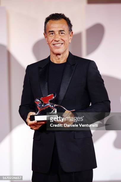Matteo Garrone poses with the Silver Lion for Best Director for film ‘Io Capitano’ at the winner's photocall at the 80th Venice International Film...