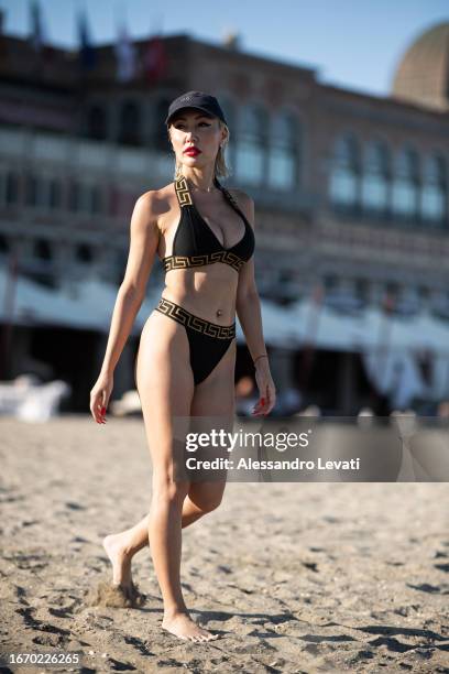 Aliia Roza poses on the beach during the 80th Venice International Film Festival on September 09, 2023 in Venice, Italy.