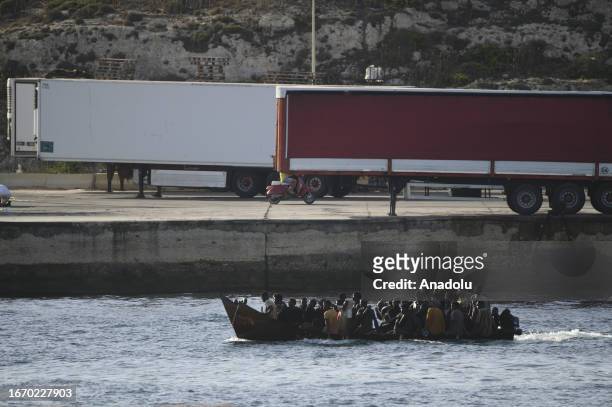Migrants arrive at the Lampedusa Island on September 16, 2023 in Italy. The small Sicilian island of Lampedusa is overwhelmed with nearly 7000...
