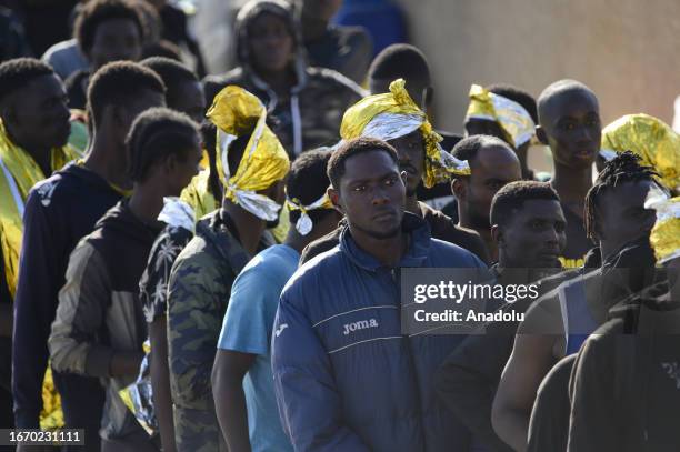 Migrants are seen waiting in queque in Lampedusa, Italy on September 16, 2023. The small Sicilian island of Lampedusa is overwhelmed with nearly 7000...
