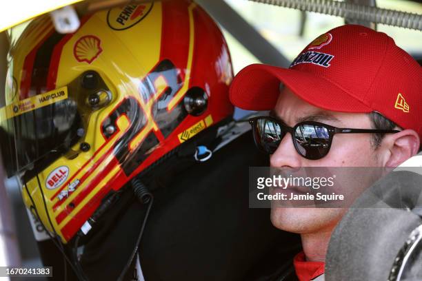 Joey Logano, driver of the Shell Pennzoil Ford, sits in his car during qualifying for the NASCAR Cup Series Hollywood Casino 400 at Kansas Speedway...