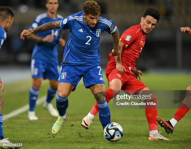 Giovanni Di Lorenzo of Italy competes for the ball with Jani Atanasov of North Macedonia during the UEFA EURO 2024 European qualifier match between...