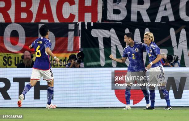 Junya Ito of Japan celebrates with teammate Yukinari Sugawara after scoring the team's first goal during the international friendly match between...