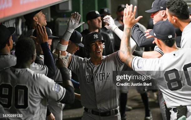 Oswaldo Cabrera of the New York Yankees celebrates with teammates in the dugout after hitting a solo home run in the eighth inning during the game...