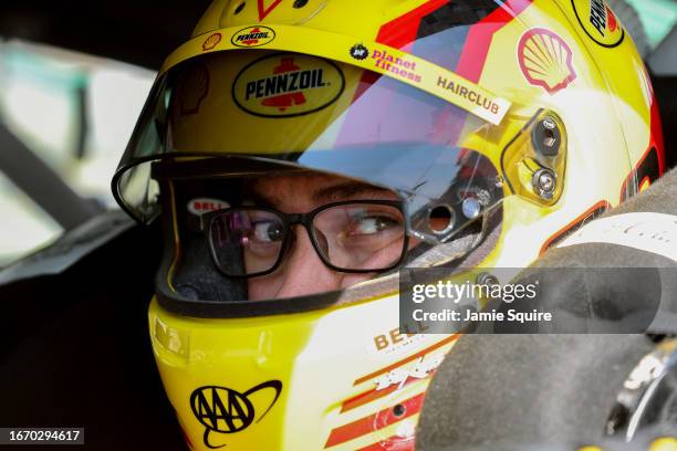 Joey Logano, driver of the Shell Pennzoil Ford, sits in his car during qualifying for the NASCAR Cup Series Hollywood Casino 400 at Kansas Speedway...