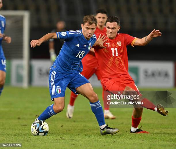 Nicolo Barella of Italy competes for the ball with Jani Atanasov of North Macedonia during the UEFA EURO 2024 European qualifier match between North...