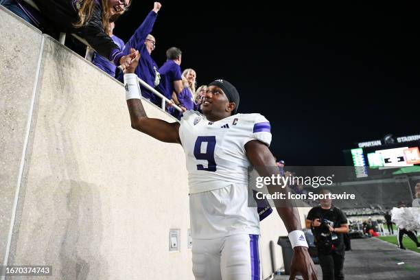 Washington Huskies quarterback Michel Penix Jr. Celebrates with fans following a college football game between the Michigan State Spartans and...