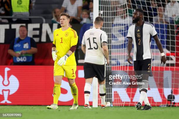 Marc-Andre ter Stegen and Antonio Ruediger of Germany look dejected after Takuma Asano of Japan scores their team's third goal during the...