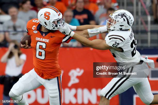 Garrett Shrader of the Syracuse Orange runs the ball as Boone Bonnema of the Western Michigan Broncos is called for a face mask penalty during the...