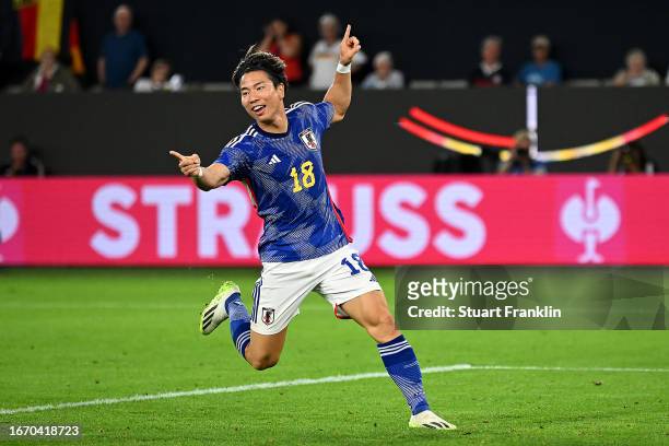 Takuma Asano of Japan celebrates after scoring the team's third goal during the international friendly match between Germany and Japan at Volkswagen...