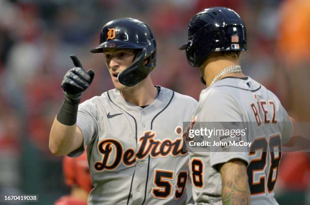 Zack Short of the Detroit Tigers celebrates a three run home run with Javier Baez in the second inning while playing the Los Angeles Angels at Angel...