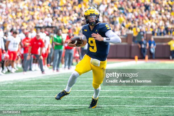 McCarthy of the Michigan Wolverines runs with the ball for yardage during the first half of a college football game against the UNLV Rebels at...