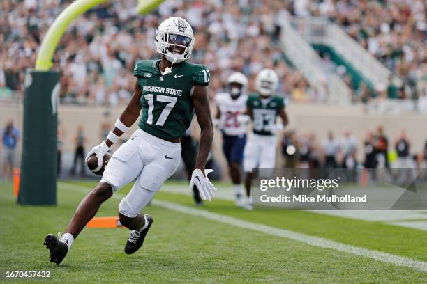 Tre Mosley of the Michigan State Spartans celebrates a touchdown in the first quarter of a game against the Richmond Spiders at Spartan Stadium on...