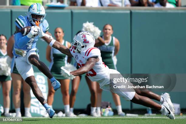 Jha'Quan Jackson of the Tulane Green Wave catches the ball for a touchdown as Trey Washington of the Mississippi Rebels defends during the first half...