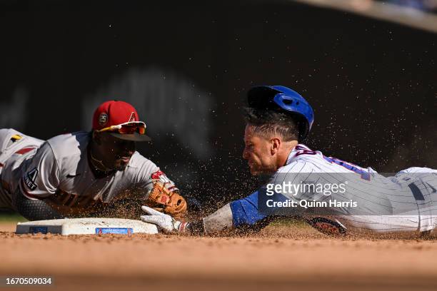 Yan Gomes of the Chicago Cubs is tagged out trying to advance to second base in the ninth inning against Geraldo Perdomo of the Arizona Diamondbacks...