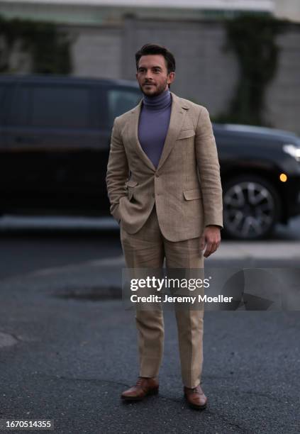 Jonathan Bailey is seen outside Ralph Lauren show wearing lilac colored turtle neck, beige colored suit and brown leather suit shoes on September 08,...