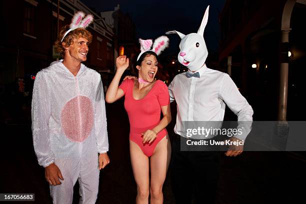 friends having fun on road at night - rabbit costume stock pictures, royalty-free photos & images