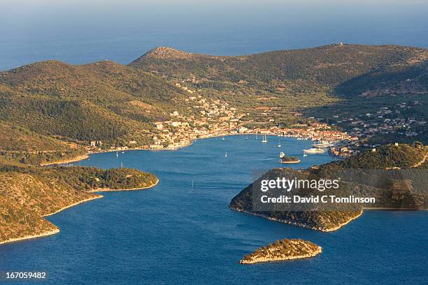 view across sea to distant vathy, ithaca, greece - ithaca stock pictures, royalty-free photos & images
