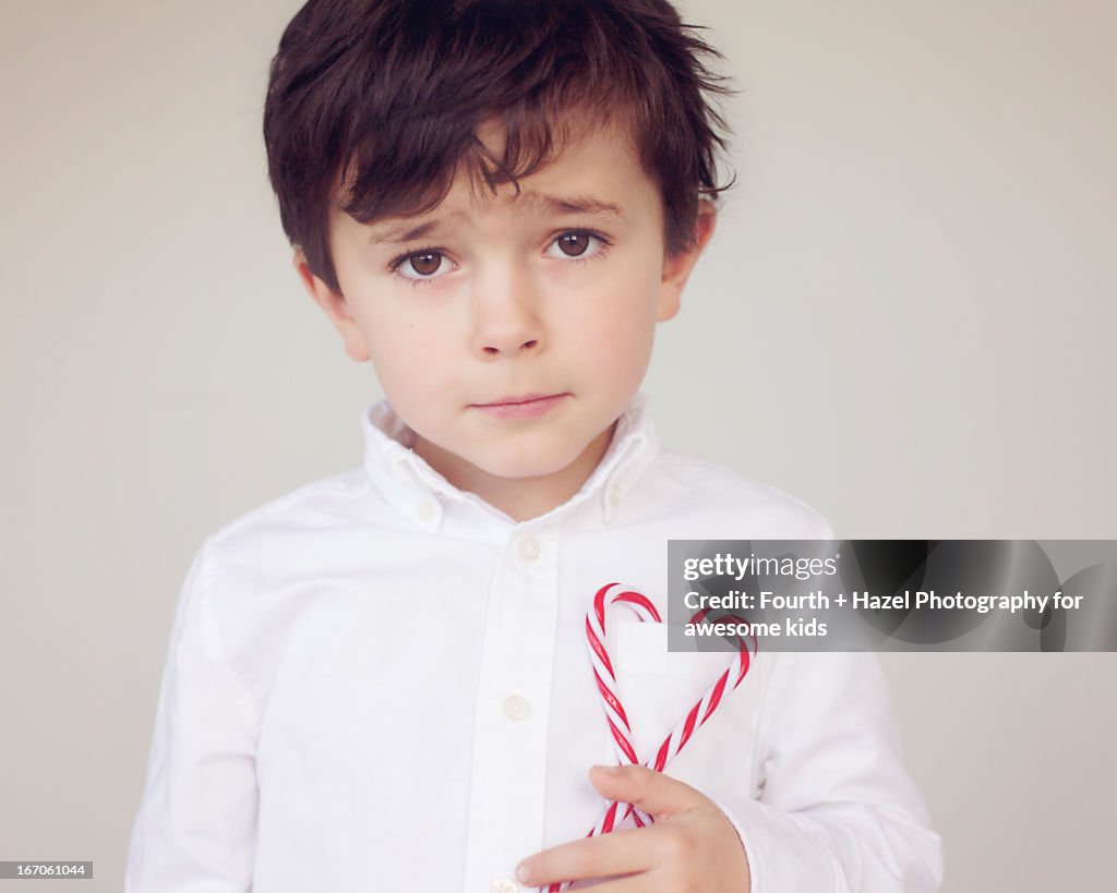 Boy in dress shirt with candy cane