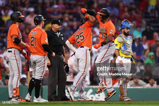 Aaron Hicks of the Baltimore Orioles celebrates with Anthony Santander after hitting a three-run home run during the third inning against the Boston...