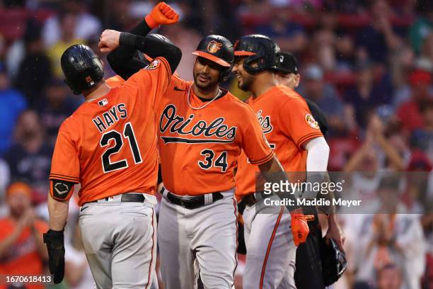 Aaron Hicks of the Baltimore Orioles celebrates with Austin Hays after hitting a three-run home run during the third inning against the Boston Red...