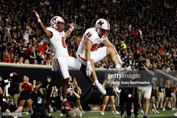 Miami Redhawks running back Kevin Davis reacts with teammate tight end Jack DeJarld during the game against the Miami Redhawks and the Cincinnati...
