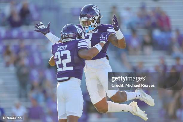 Evan Smith and Jaheem Joseph of the Northwestern Wildcats celebrate a fourth down stop against the UTEP Miners during the second half at Ryan Field...