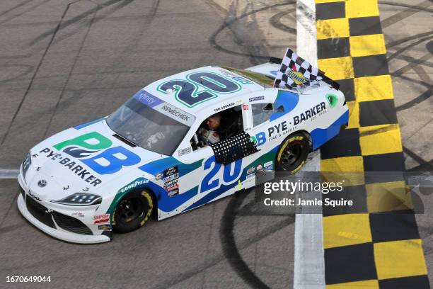 John Hunter Nemechek, driver of the Pye Barker Fire & Safety Toyota, drives with the checkered flag after winning the NASCAR Xfinity Series Kansas...