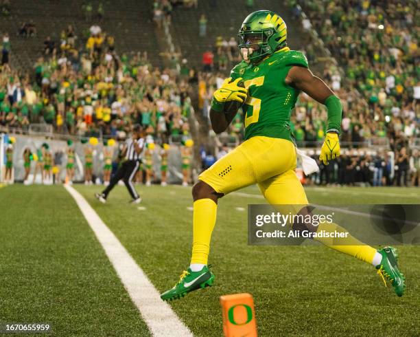 Wide receiver Traeshon Holden of the Oregon Ducks runs the ball in for a touchdown during the second half of the game against the Hawaii Rainbow...